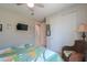 Bedroom featuring closet, rattan chair, ceiling fan, and exterior views at 40725 W Hall Dr, Maricopa, AZ 85138