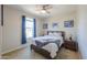 Comfortable bedroom featuring a ceiling fan, natural light, and tasteful decor at 40725 W Hall Dr, Maricopa, AZ 85138