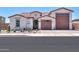 Charming single-story home with desert landscaping, tile roof and a three-car garage at 40725 W Hall Dr, Maricopa, AZ 85138