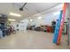 Spacious garage with epoxy flooring and lots of storage at 40725 W Hall Dr, Maricopa, AZ 85138