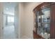 Bright hallway with a display cabinet showing fine china and glassware at 40725 W Hall Dr, Maricopa, AZ 85138