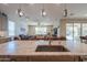 Close-up on the granite kitchen island countertops and stainless steel sink with view to the living room at 40725 W Hall Dr, Maricopa, AZ 85138