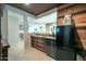 Well-appointed kitchen with custom cabinets, beverage fridge, and decorative ceiling at 40725 W Hall Dr, Maricopa, AZ 85138