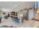 Open kitchen boasts a large island with barstool seating, stainless steel appliances, and a built-in bar area at 40725 W Hall Dr, Maricopa, AZ 85138