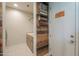 Functional laundry room with built-in shelving and rustic wood accents at 40725 W Hall Dr, Maricopa, AZ 85138
