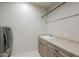 Well-equipped laundry area with a large utility sink and modern cabinets at 40725 W Hall Dr, Maricopa, AZ 85138