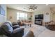 Cozy living room with recessed lighting, ceiling fan and stylish, comfortable furniture at 40725 W Hall Dr, Maricopa, AZ 85138
