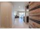 Inviting living space showcasing decorative wood wall and an open floorplan at 40725 W Hall Dr, Maricopa, AZ 85138