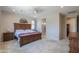 Spacious main bedroom with a ceiling fan and a doorway to a private bathroom at 40725 W Hall Dr, Maricopa, AZ 85138