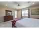 Inviting main bedroom with a view, large windows, and carpeted floors at 40725 W Hall Dr, Maricopa, AZ 85138
