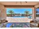 Relaxing covered patio with a view of the sparkling pool and waterfront at 40725 W Hall Dr, Maricopa, AZ 85138