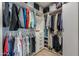 Custom walk-in closet with shelves, drawers and hanging storage at 40725 W Hall Dr, Maricopa, AZ 85138