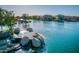 Scenic shot of a lake with a rocky waterfall and surrounding residential community, creating a tranquil setting at 40725 W Hall Dr, Maricopa, AZ 85138