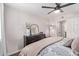 Bedroom features a dark wood dresser, fan and artwork at 4120 N 78Th St # 216, Scottsdale, AZ 85251