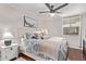 Bright bedroom with large window, ceiling fan, wood floor, and comfortable bed at 4120 N 78Th St # 216, Scottsdale, AZ 85251