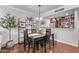 Bright dining area with a wooden table, stylish shelving, and an open view of the kitchen at 4120 N 78Th St # 216, Scottsdale, AZ 85251