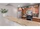 Open kitchen with wooden cabinets, stainless steel appliances, and granite countertops provides ample counter space at 4120 N 78Th St # 216, Scottsdale, AZ 85251