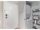 Hallway showing in-unit laundry closet with stacked washer and dryer at 4120 N 78Th St # 216, Scottsdale, AZ 85251
