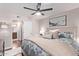 Comfortable bedroom featuring a ceiling fan, decorative pillows, and a glimpse of an en-suite bathroom at 4120 N 78Th St # 216, Scottsdale, AZ 85251