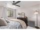 Relaxing main bedroom featuring a ceiling fan, large window, dresser, and soft lighting for a serene ambiance at 4120 N 78Th St # 216, Scottsdale, AZ 85251