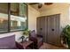 Cozy patio with wicker furniture, privacy hedge and storage at 4120 N 78Th St # 216, Scottsdale, AZ 85251