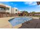 Community pool with grilling area, landscaping and surrounding buildings at 4120 N 78Th St # 216, Scottsdale, AZ 85251