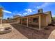 Backyard featuring an extended covered patio perfect for gatherings, along with a cozy fire pit at 4629 N 78Th Dr, Phoenix, AZ 85033