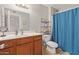 Bathroom with double vanity, tile flooring, and a shower with blue curtain at 4629 N 78Th Dr, Phoenix, AZ 85033