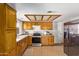 Well-equipped kitchen with stainless steel appliances, wood cabinetry, and tile floors at 4629 N 78Th Dr, Phoenix, AZ 85033