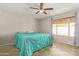 Calm main bedroom with tile flooring, ceiling fan and natural light from the large window at 4629 N 78Th Dr, Phoenix, AZ 85033