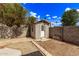 Backyard storage shed surrounded by brick pavers and concrete block fence at 4629 N 78Th Dr, Phoenix, AZ 85033