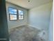 Unfinished bedroom with ample natural light, freshly painted white walls, and unfinished flooring at 46819 W Cansados Rd, Maricopa, AZ 85139