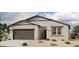 Charming single-story home with neutral stucco, dark trim, a two-car garage, and low maintenance front yard landscaping at 46819 W Cansados Rd, Maricopa, AZ 85139