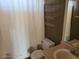 Cozy bathroom featuring a toilet, shower with curtain, and a vanity sink with mirror at 5402 E Mckellips Rd # 103, Mesa, AZ 85215