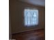 Bedroom featuring wood-look flooring and a window with lace curtains at 5402 E Mckellips Rd # 103, Mesa, AZ 85215