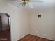 Empty bedroom featuring wood floors, ceiling fan, and TV mount at 5402 E Mckellips Rd # 103, Mesa, AZ 85215