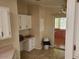 Well-lit kitchen featuring bright cabinets, tile flooring, and additional storage at 5402 E Mckellips Rd # 103, Mesa, AZ 85215