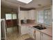 Well-lit kitchen featuring bright cabinets, tile flooring, and stainless steel sink at 5402 E Mckellips Rd # 103, Mesa, AZ 85215