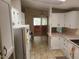 Well-lit kitchen featuring bright cabinets, tile flooring, and stainless steel sink at 5402 E Mckellips Rd # 103, Mesa, AZ 85215