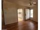 Cozy living room featuring hardwood flooring, access to the kitchen, and a ceiling fan at 5402 E Mckellips Rd # 103, Mesa, AZ 85215