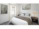 Well-lit bedroom with a queen-sized bed, window, and contemporary artwork at 5761 E Iris Dr, Florence, AZ 85132