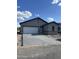Newly constructed single-story home with a spacious driveway leading to an attached two-car garage at 5761 E Iris Dr, Florence, AZ 85132