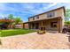 Large backyard featuring pavers, artificial grass, and outdoor patio area; great for entertaining guests at 5910 W Blue Sky Dr, Phoenix, AZ 85083