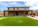 Spacious backyard featuring artificial turf, covered patio, putting green, and outdoor recreation area at 5910 W Blue Sky Dr, Phoenix, AZ 85083