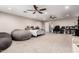 Spacious basement featuring carpeted floors, comfortable seating, a bed and an office area at 5910 W Blue Sky Dr, Phoenix, AZ 85083