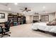 Spacious basement featuring a bookcase, carpeted floor, comfortable seating, a telescope and a bed at 5910 W Blue Sky Dr, Phoenix, AZ 85083