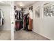 Spacious walk-in closet featuring carpet, built-in shelving, and window for natural light at 5910 W Blue Sky Dr, Phoenix, AZ 85083