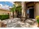 Exterior view of the entryway featuring a mature palm tree, covered patio and entry door at 5910 W Blue Sky Dr, Phoenix, AZ 85083