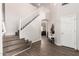 Bright entryway featuring hardwood floors, white walls, and a staircase leading to the upper level at 5910 W Blue Sky Dr, Phoenix, AZ 85083