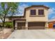 Two story home featuring a three car garage, desert landscaping and a mature shade tree at 5910 W Blue Sky Dr, Phoenix, AZ 85083